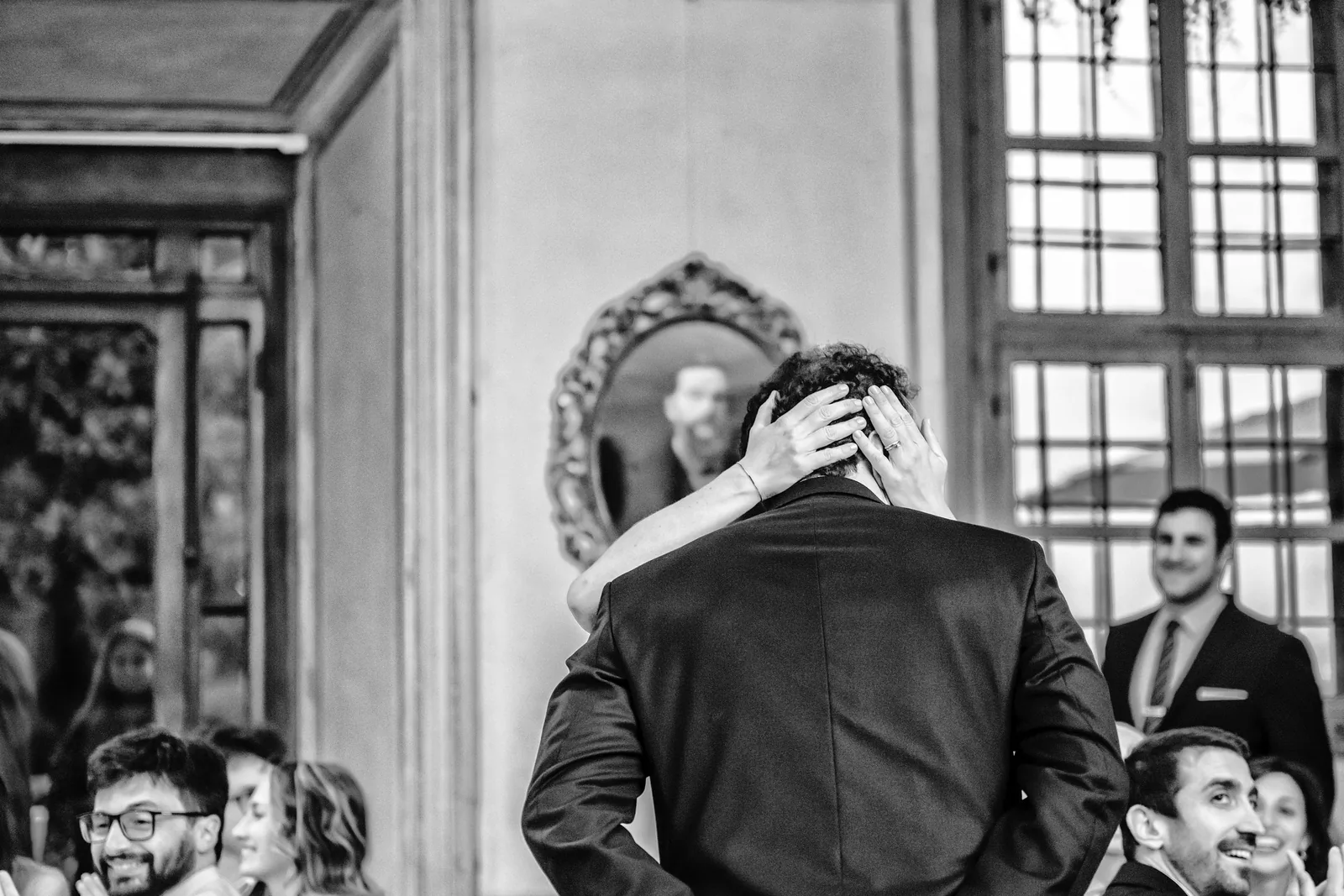 An embrace reflected in an oval mirror, Palazzo La Marmora, black and white