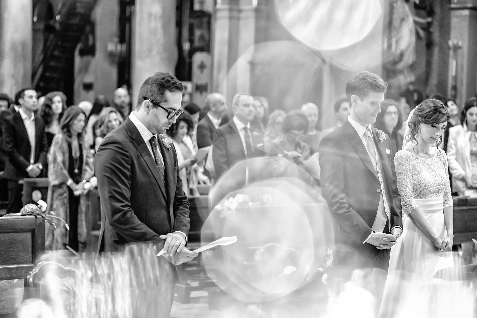 A reading during the ceremony seen through circles of light, Turin, black and white